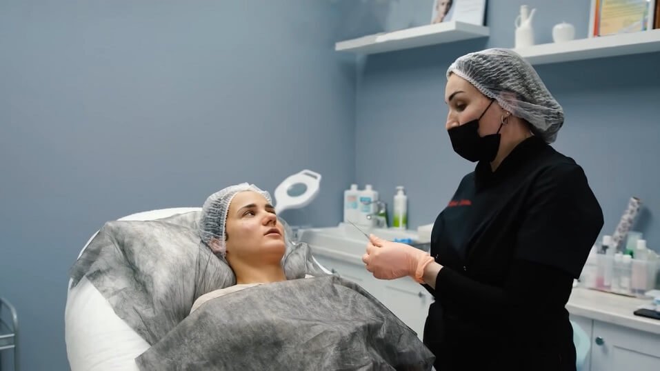 doctor preparing patient for chin filler treatment 